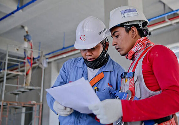 two men looking at form